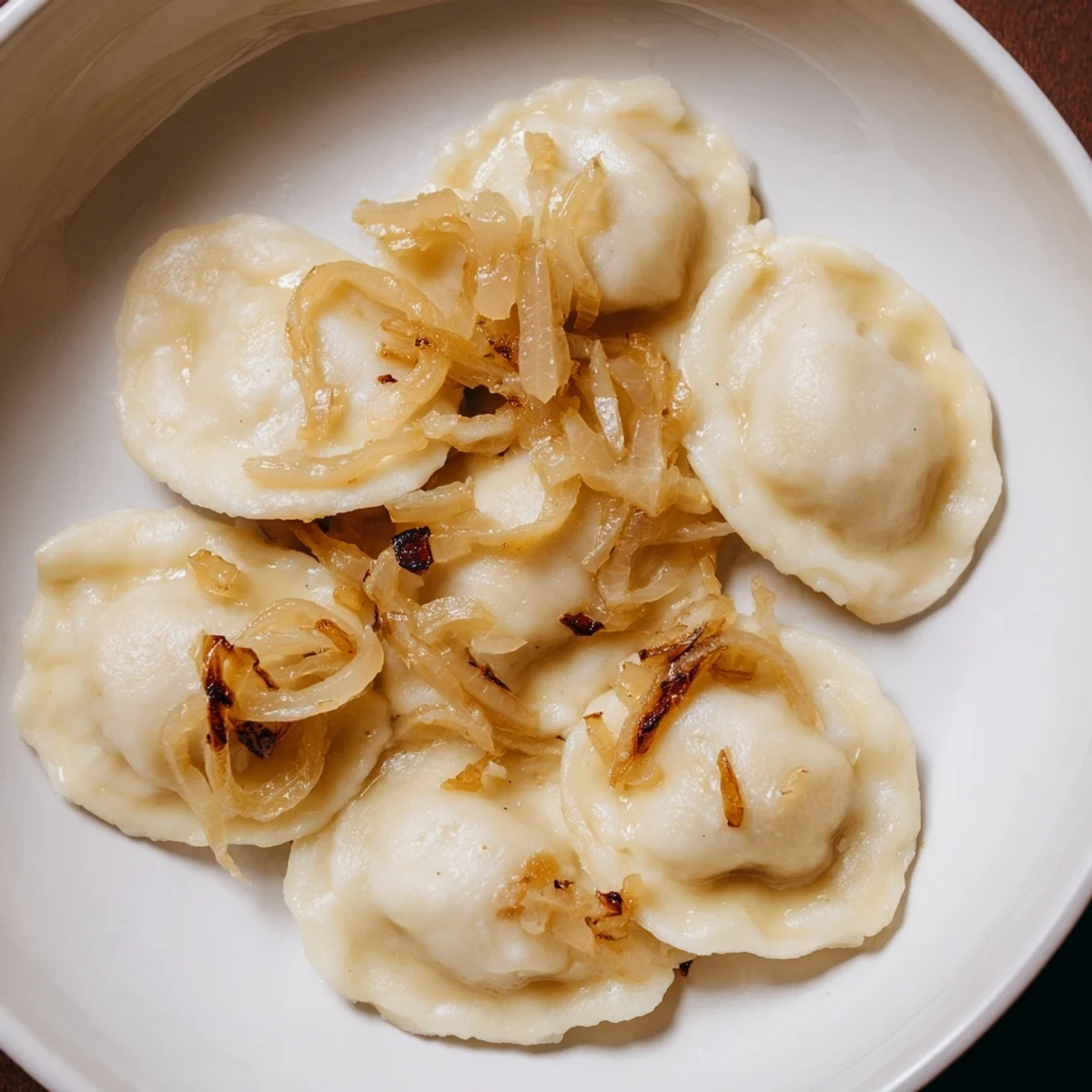 Warm, savory photo of golden Authentic Potato and Cheese Pierogi Ruskie, a perfect comfort food.