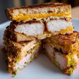 Close-up of a hearty Crispy Panko Pork Chop Grilled Cheese ready to be sliced and devoured.