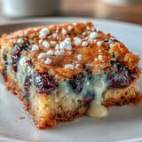 Soft and chewy blondies bursting with fresh blueberries, zesty lemon, and melted white chocolate, perfect for spring gatherings.  