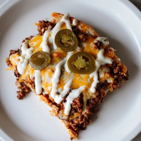Ground Beef Taco Pizza, a delicious image showing a cheesy and flavorful slice ready to eat.