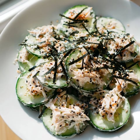 Freshly tossed California Roll Cucumber Salad with creamy mayo dressing, topped with crunchy nori and toasted sesame seeds.  