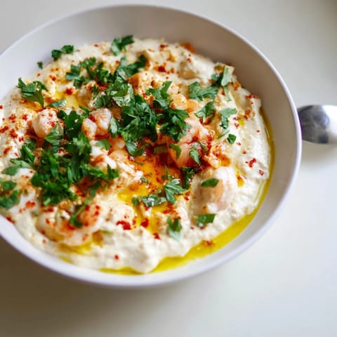 Homemade shrimp and garlic oil dip, served warm with crusty bread for dipping.