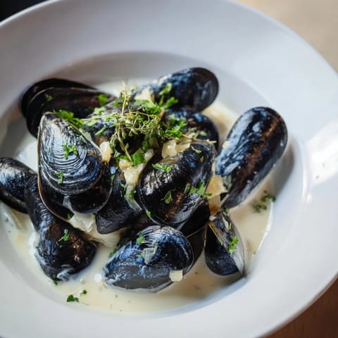 Enjoy tender 30-Minute Classic Creamy Mussels swimming in a rich, flavorful white wine broth.