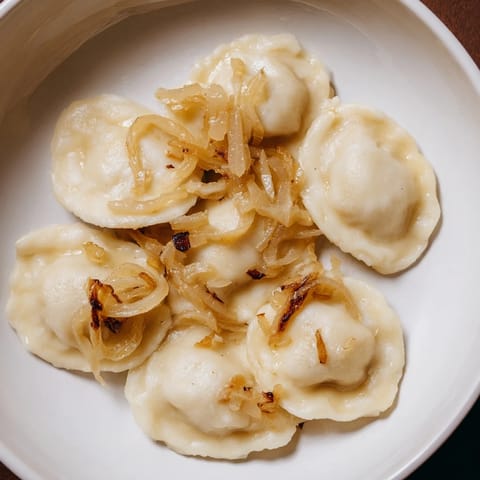 Warm, savory photo of golden Authentic Potato and Cheese Pierogi Ruskie, a perfect comfort food.