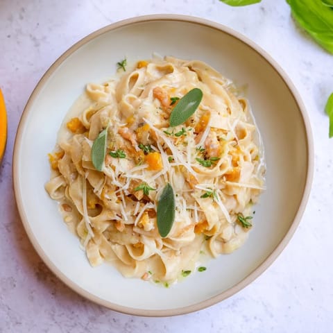 Enjoy a bowl of Healthy Creamy Pumpkin Sage Holiday Pasta, a festive vegetarian main course with creamy pumpkin.