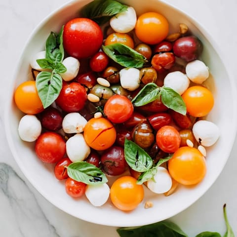 Mediterranean delight: close-up of a vibrant cherry tomato and basil ring, ready to eat.