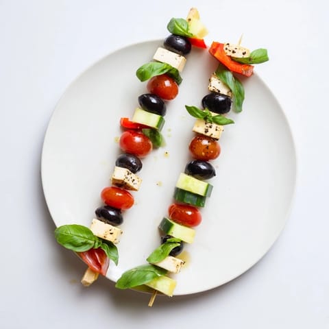 Visually stunning Double Helix Genetic Code appetizer: black olives, tomatoes, cool cucumber, and creamy cheese ready now.