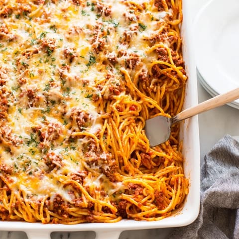 Golden brown topping on a freshly baked dish of Tinis Baked Spaghetti, ready to be served.