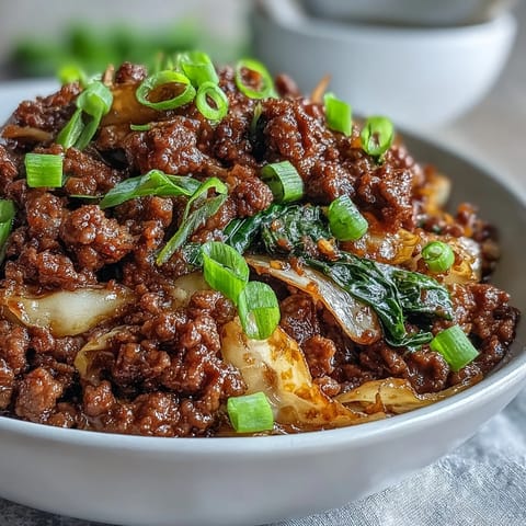Close-up of a savory Chinese Ground Beef and Cabbage Stir-Fry served in a ceramic bowl, perfect for a low-carb weeknight dinner.