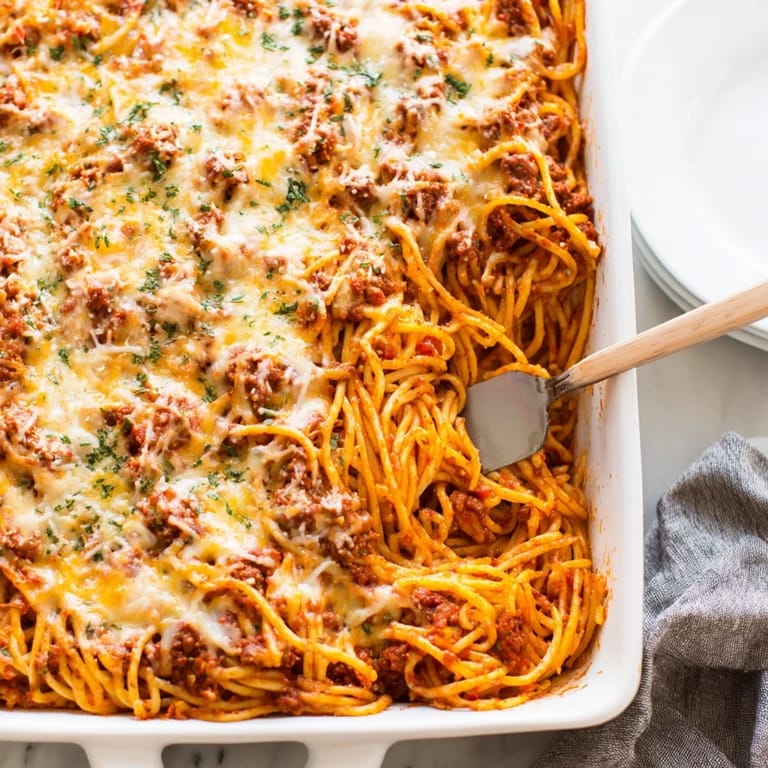 Golden brown topping on a freshly baked dish of Tinis Baked Spaghetti, ready to be served.