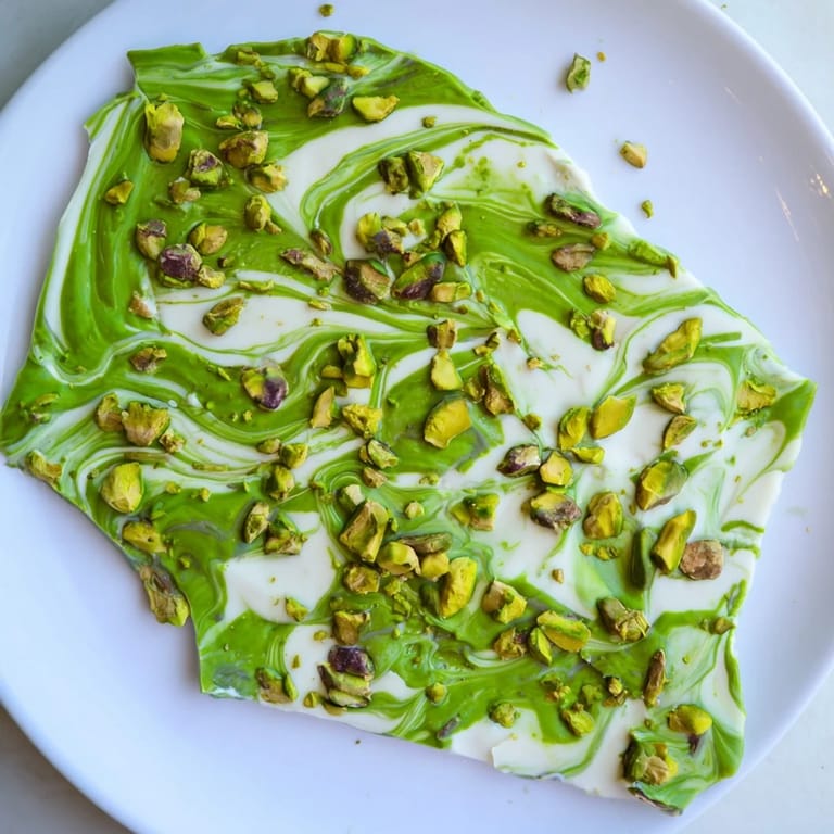 Freshly made layers of Pistachio Matcha White Chocolate, a sweet, earthy, and nutty confection ready to be served.