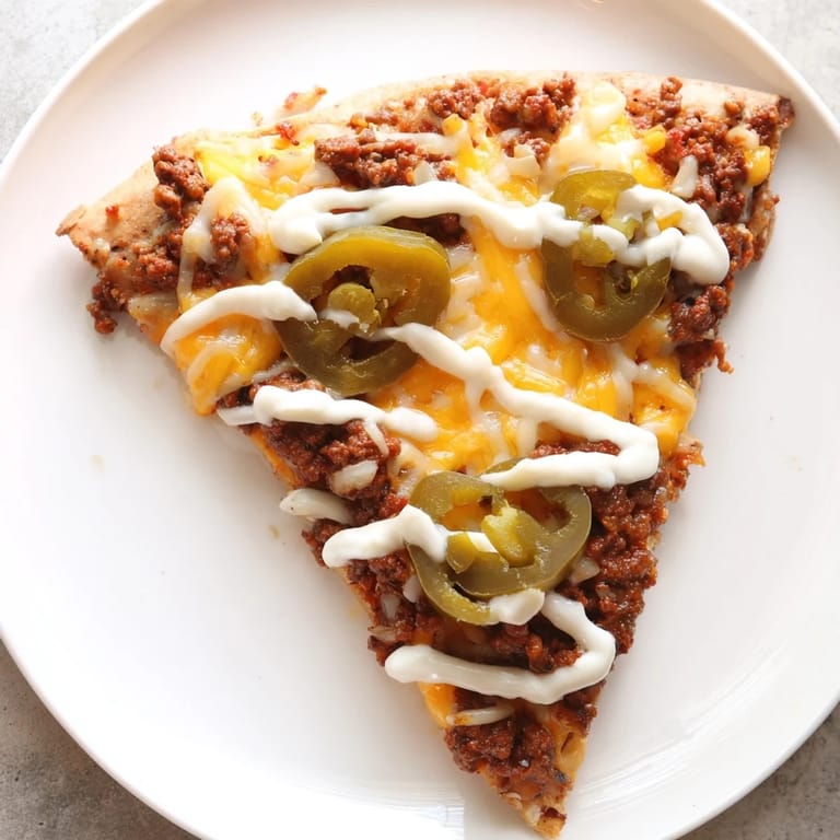 Golden crust topped with savory ground beef and jalapeños, creating a vibrant Ground Beef Taco Pizza.