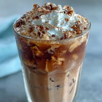 Creamy blended vanilla bean frappuccino with almond milk, topped with light whipped cream and cinnamon.