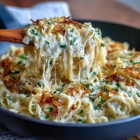 Creamy Cabbage Alfredo with tender fettuccine and sautéed cabbage in a rich Parmesan sauce.